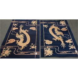  Two Chinese deep pile blue and white rugs decorated with Dragons, 187cm x 117cm (2)  