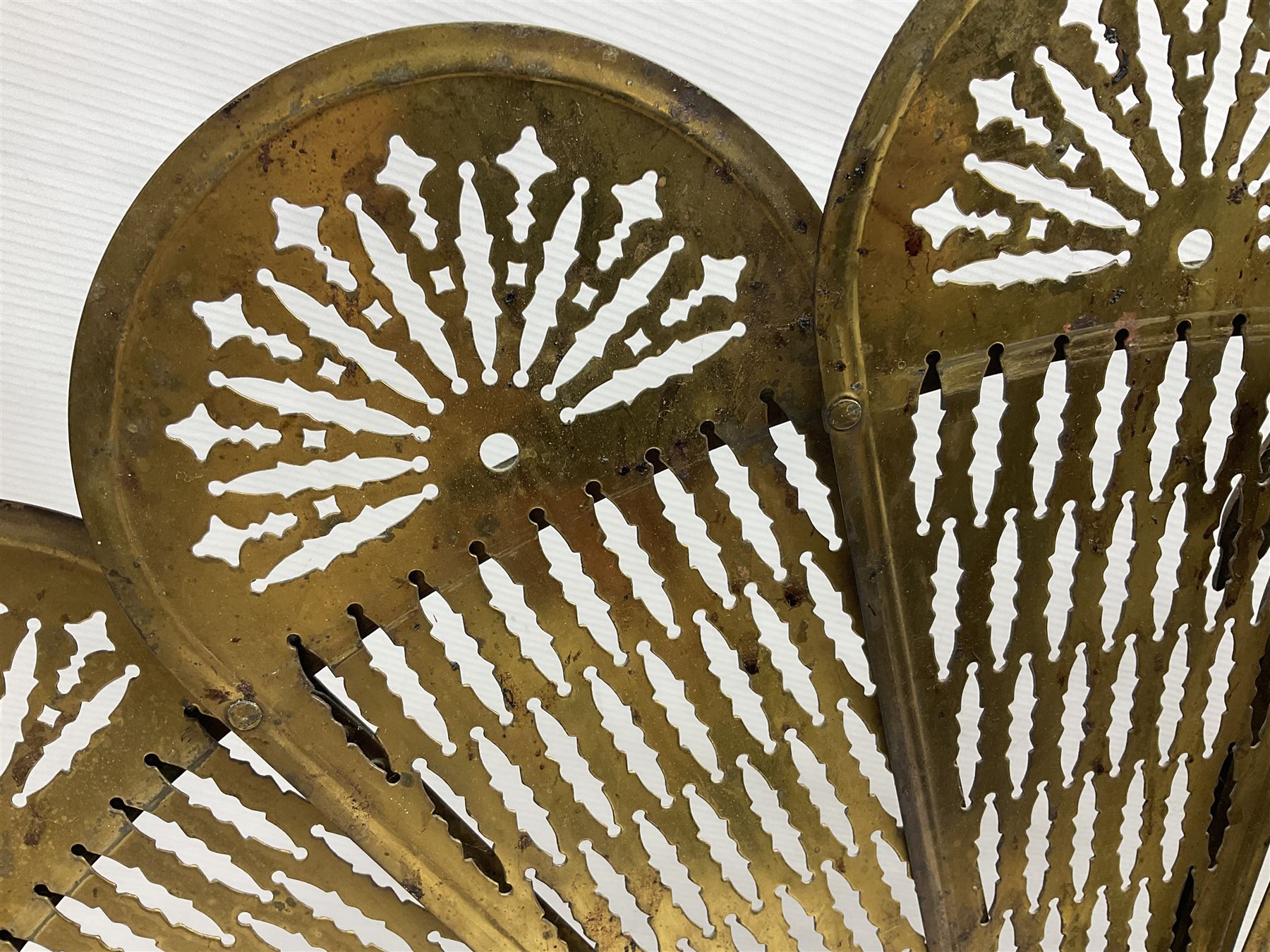 Pierced brass peacock style folding fire screen, with urn finial, H65.5cm