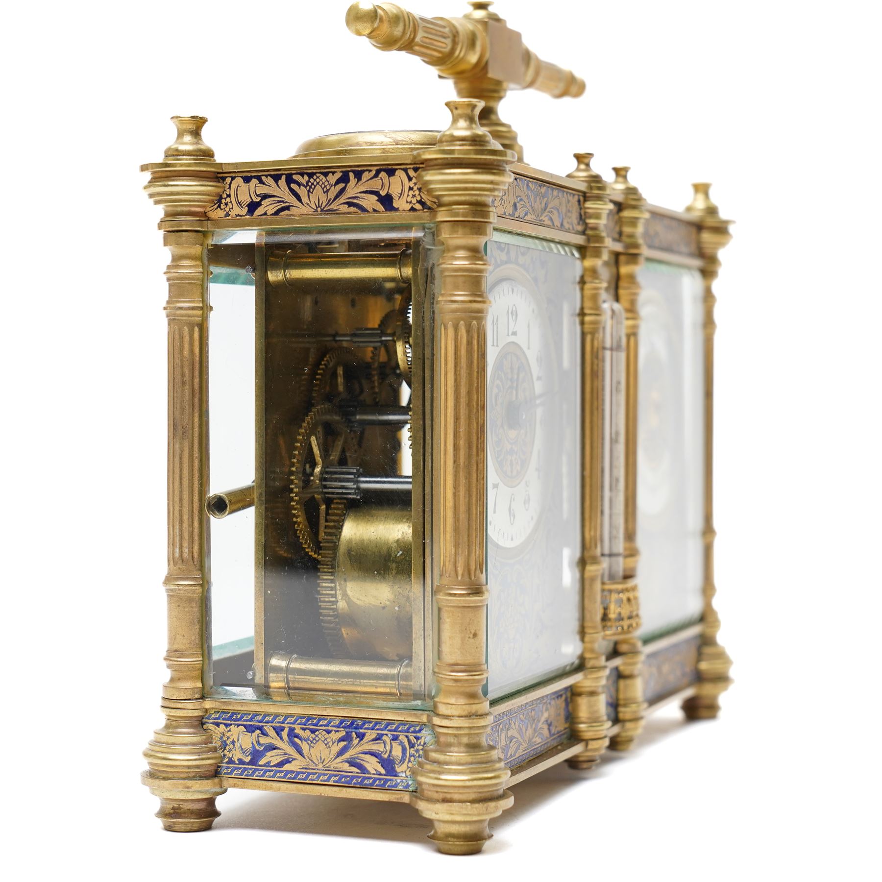 French-late 19th century combination brass carriage timepiece with barometer, thermometer and compass, with a fluted T bar handle and eight matching columns with turned finials, bands of fretted brass to the base and cornice and conforming decoration to the dial masks and dial centres, with silvered chapters to the time dial and barometer and a mercury thermometer between, the top with a circular bevelled viewing glass to the escapement and compass to the other, with a single train 8-day movement and cylinder platform escapement.  With key.
