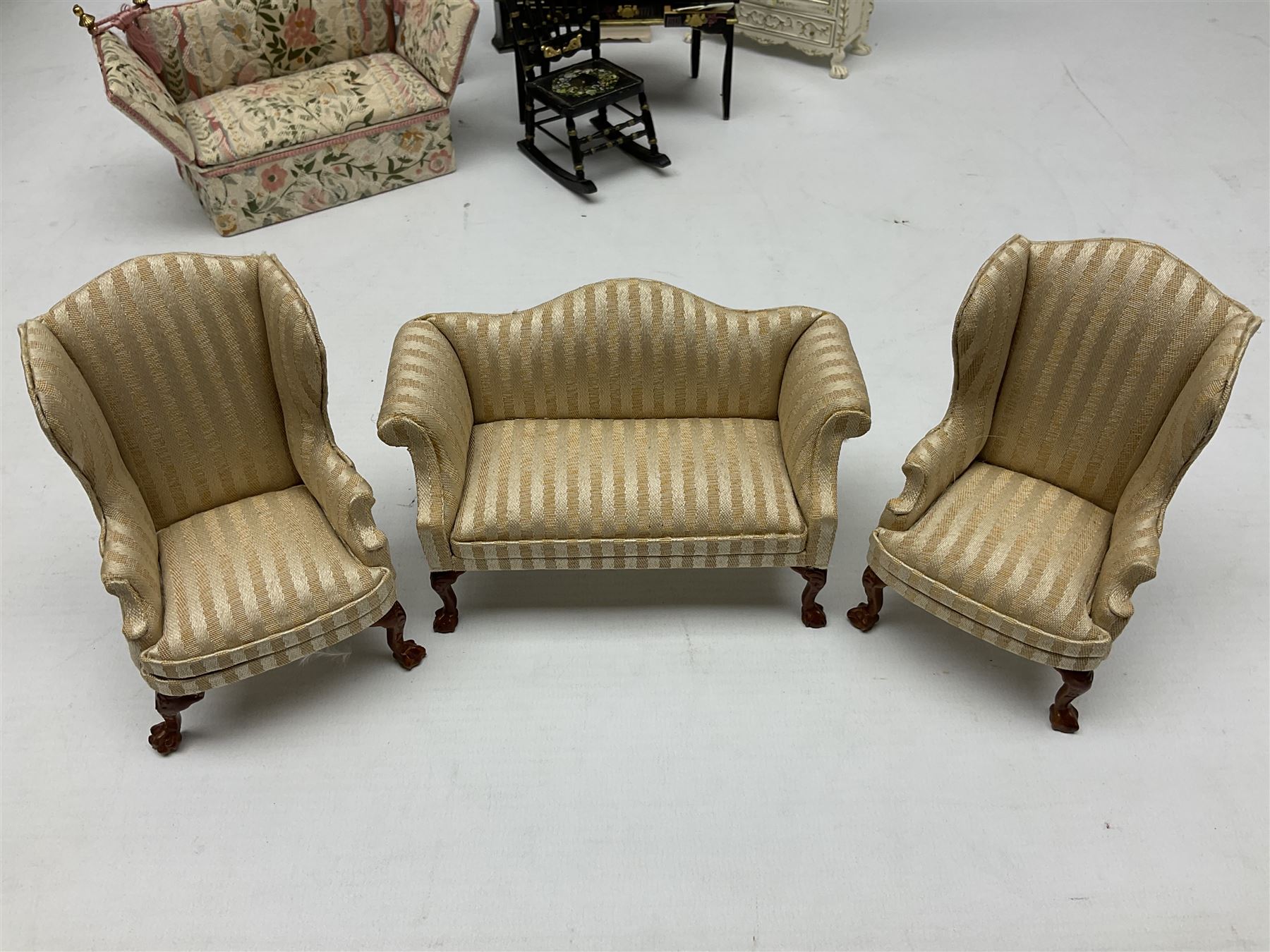 Collection of miniature dolls house furniture, to include five drawer chest painted with blossom, cream and gilt double door mirrored wardrobe, four piece lacquered style desk set, three piece suite, writing desk, wash stand, Knoll style sofa etc (14)