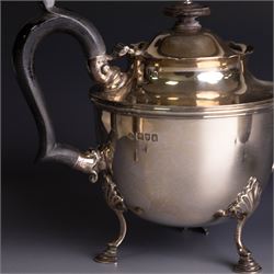 Early 20th century silver three piece bachelor's tea service, comprising teapot, open sucrier and milk jug, all of circular waisted form with shaped rims and upon three stepped feet, the teapot with ebonised wooden handle and finial, hallmarked Wakely & Wheeler, London 1914, teapot height H15cm