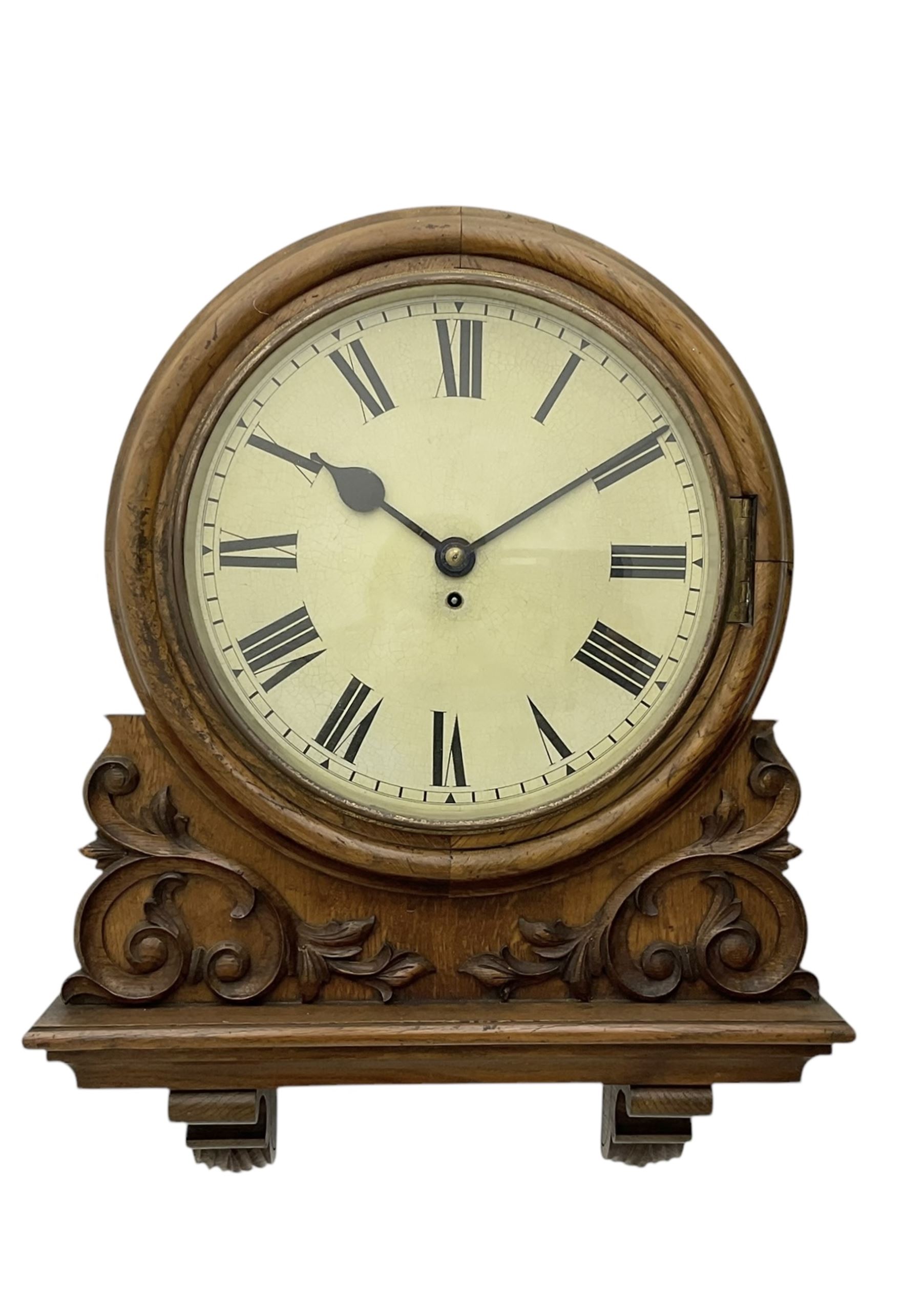 Winterhalter and Hoffmeier -  German oak cased early 20th century fusee wall clock, with a circular wooden surround and a spun brass glazed bezel to the dial, housed on an integral carved bracket with shaped corbel supports, painted dial with Roman numerals, minute track and steel spade hands, dial pinned directly to a four pillar chain driven fusee movement with a recoil anchor escapement. With pendulum and key. 
German fusee movements by Winterhalter and Hoffmeier are comparatively rare, especially housed in carved wall clocks of this description. 
