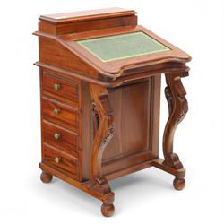 Victorian design mahogany Davenport desk, the sloped writing surface inset with tooled green leather and hinged to reveal a fitted interior, with a pen compartment to the raised gallery back, four drawers to each side, on carved scrolled supports with acanthus detail, raised on turned feet