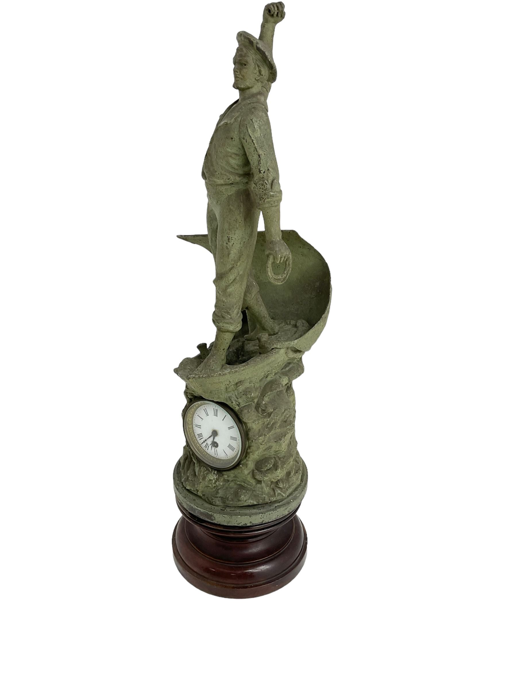 Edwardian - Large figural clock with a Verdigris finish mounted on a mahogany plinth, detailed depiction of a fisherman in a sailing boat entitled 