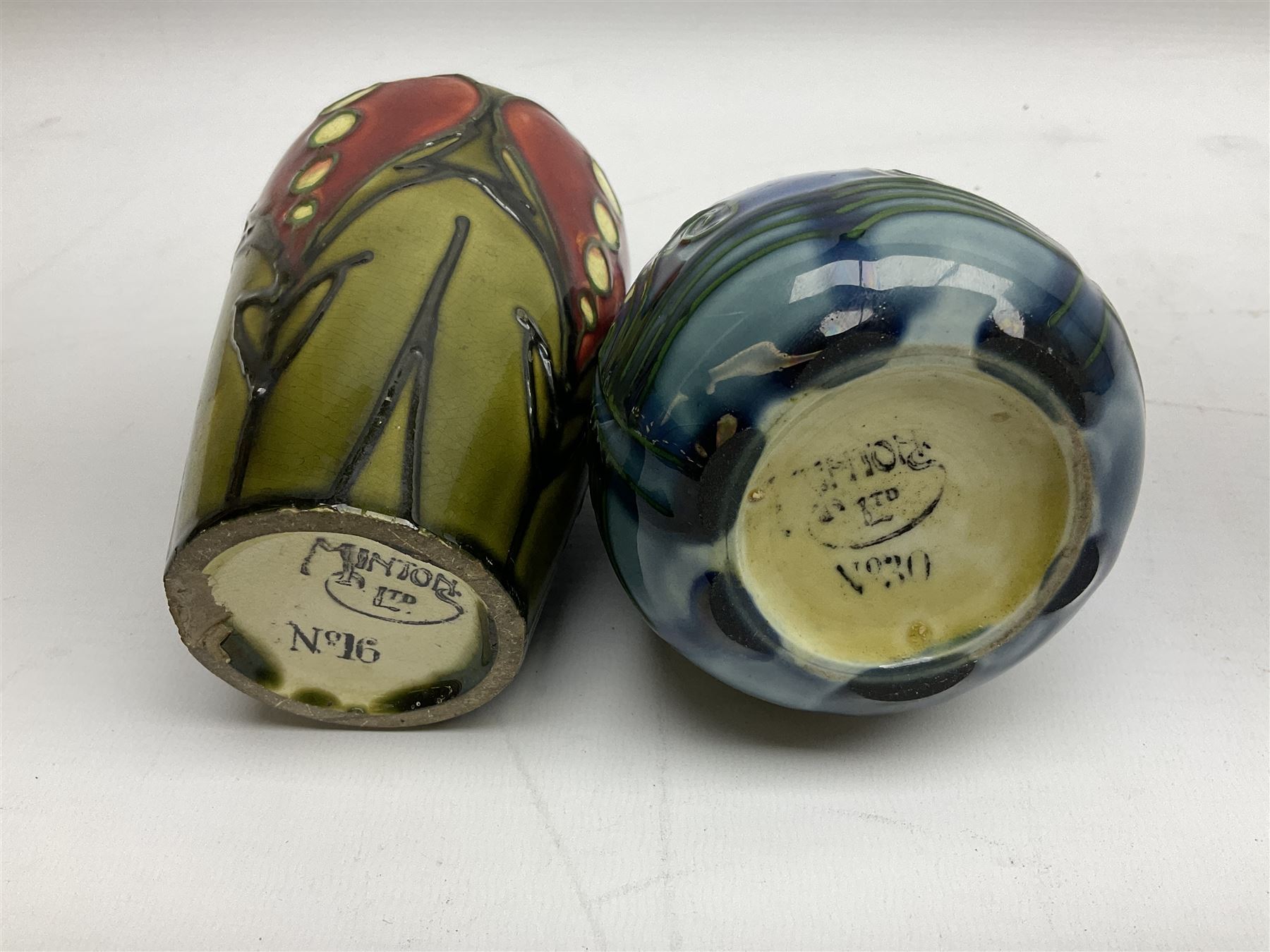 Minton Secessionist vase, with tube-lined stylised flower head decoration on a blue ground, printed mark to base 'Minton Ltd, No. 30', together with another Minton Secessionist tubelined vase,  printed mark to base 'Minton Ltd, No. 16', tallest example H13.5cm