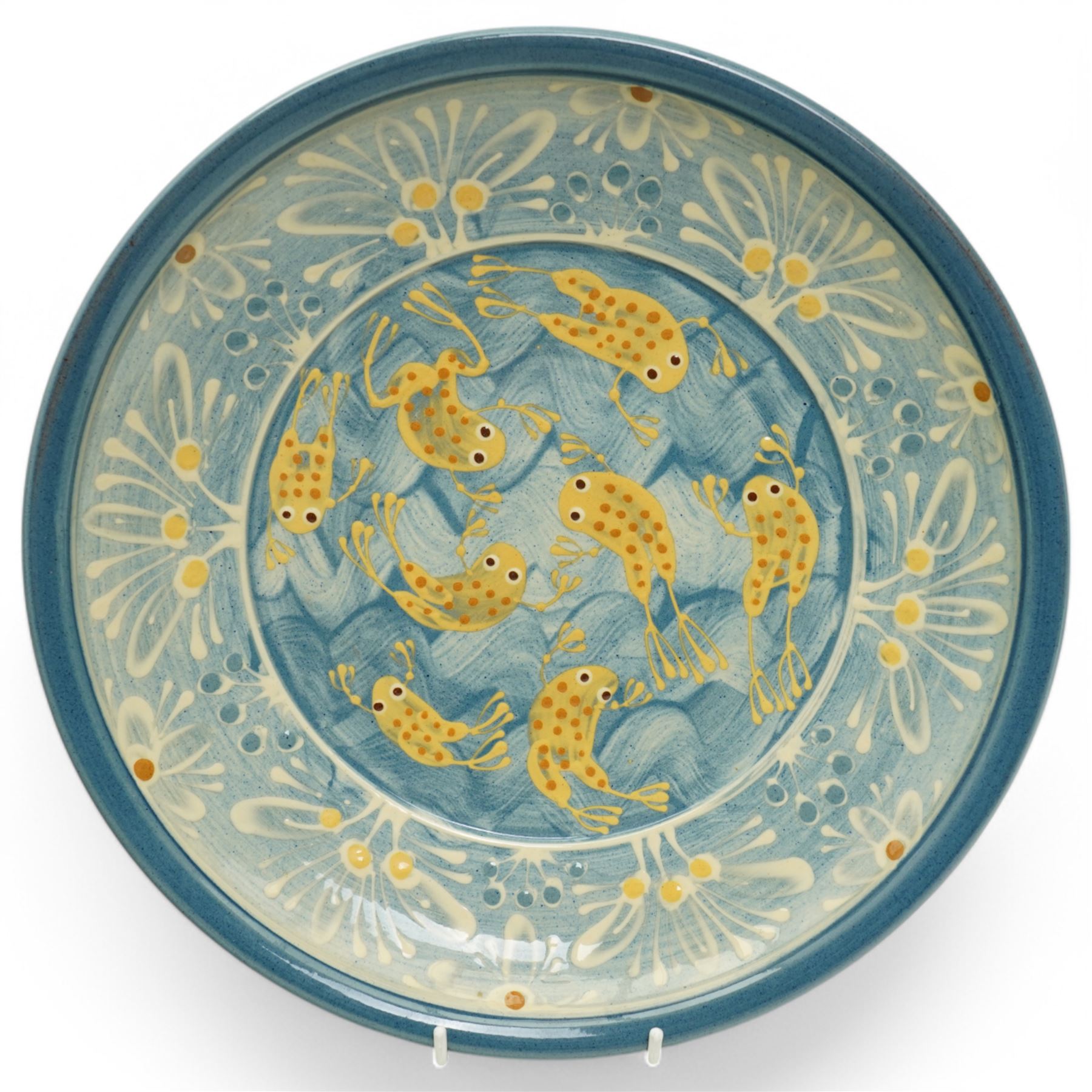 Coxwold studio pottery charger, decorated in a blue and yellow glaze with swimming frogs, together with three mugs with similar swimming fish and frogs, each painted or impressed mark, charger D33cm (4)
