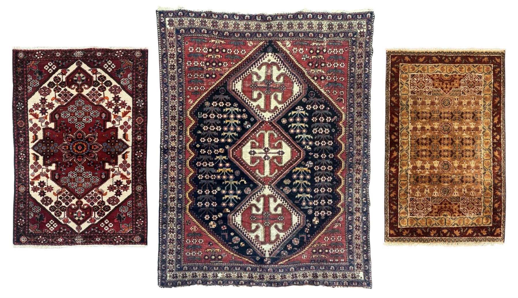 Persian Heriz wool rug, red and ivory field with floral medallion, geometric spandrels, and floral border (157cm x 107cm); Kurdish Shairwan wool rug, red and navy field with three medallions, geometric crosses and serrated border (200cm x 155cm); Persian Qashqai wool rug, golden-yellow field with boteh motifs and wide floral border (127cm x 82cm)