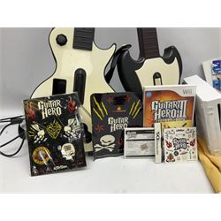 Nintendo Wii console, four controllers with cases and four nunchucks, Wii sensor bar, balance board and dance mat. Guitar hero wireless guitar for Wii and Redoctane wired guitar. Nintendo DS lite handheld gaming console, console and game cases and Guitar Hero Redoctane Guitar Grip. Selection of Nintendo Wii and Nintendo DS lite games to include Super Mario Galaxy, Guitar Hero, Wii Fit, Legend of Zelda games etc. Archos AV400 Series pocket video recorder with accessories, cradle and remote, in three boxes