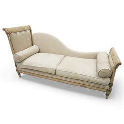 19th Century French day bed, the shaped back and scroll ends with fluted supports and carved rosettes, upholstered in natural linen with loose seat cushions and bolster pillows