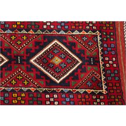 Two hand-knotted rugs, comprising Persian runner and Turkoman prayer rug, Persian hand-knotted runner, red and dark navy ground with four diamond medallions and geometric motifs, enclosed by multicoloured geometric border, striped kilim ends with fringes, H244cm, W58cm; Turkoman hand-knotted prayer rug, ivory mihrab field decorated with repeating stylised geometric motifs, enclosed by multiple geometric borders in madder red and brown, with fringed ends, H150cm, W93cm