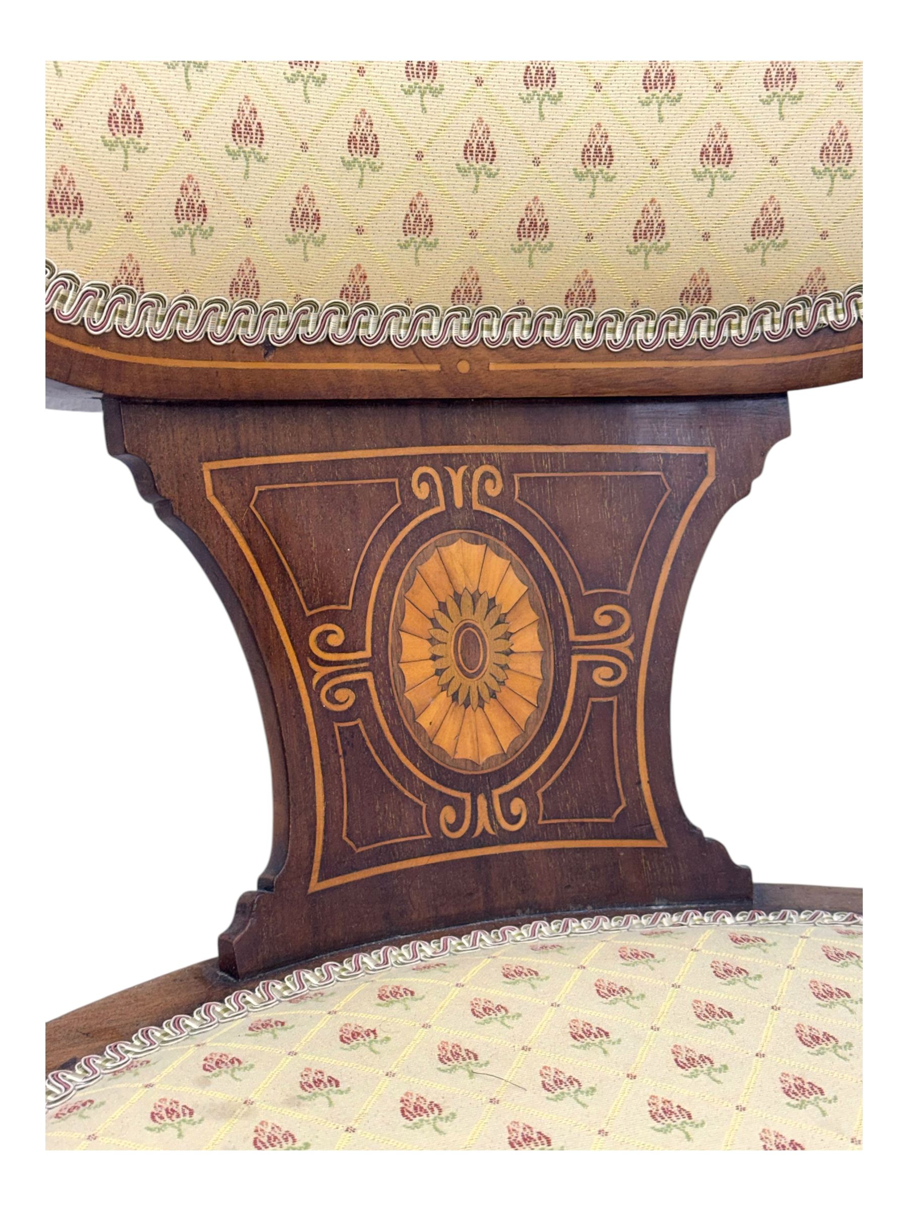 Edwardian inlaid mahogany X-frame armchair, upholstered seat and shield-back, curved front supports united by turned H-stretcher (W57cm, D58cm, H94cm); similar inlaid mahogany armchair, raised on cabriole supports united by cross-stretcher (W62cm, D60cm, H82cm) 