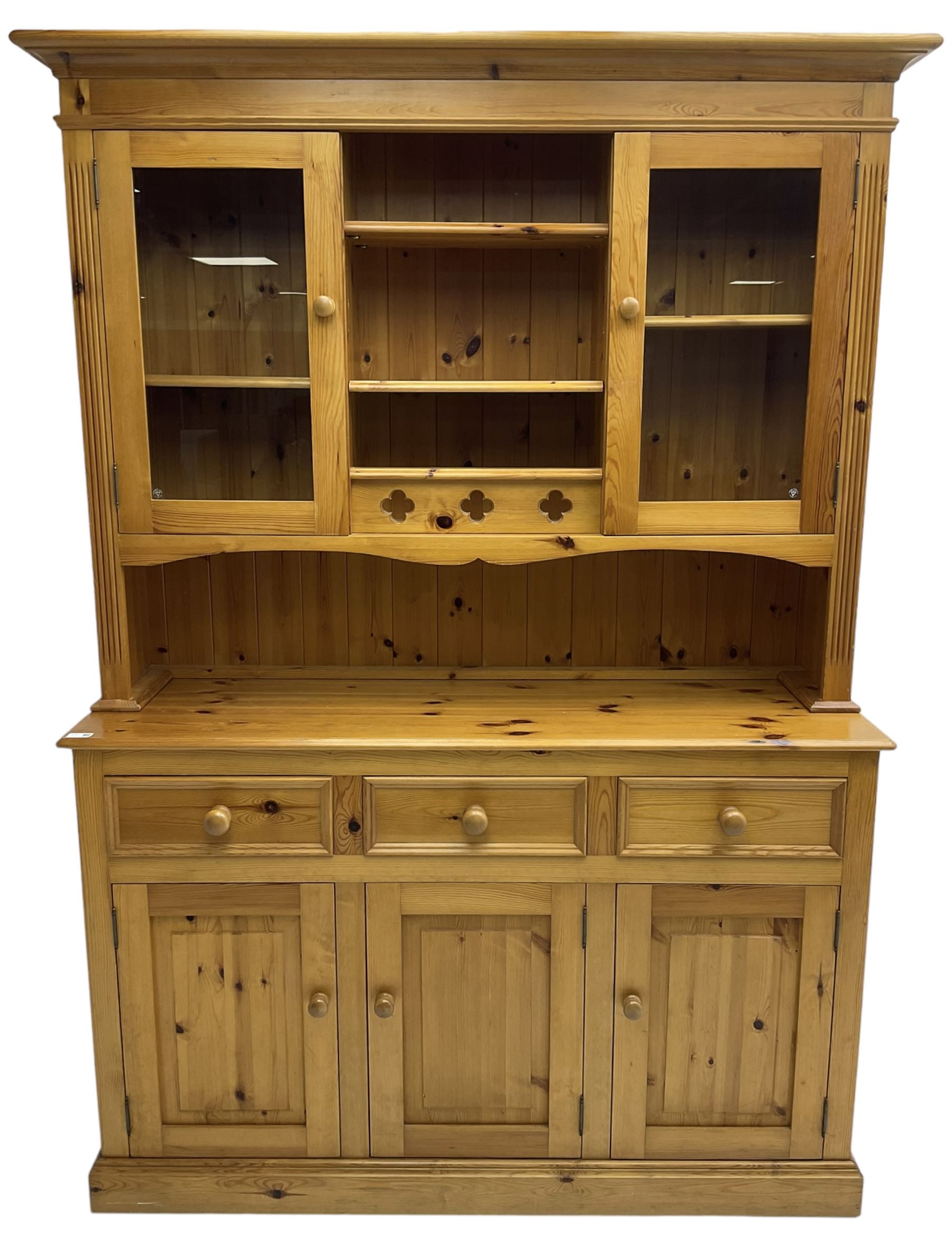 Traditional pine dresser, the rack fitted with two shelves flanked by glazed cupboards, the base with three drawers over three panelled cupboards