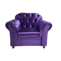 Chesterfield shaped armchair, upholstered in buttoned purple fabric, with scatter cushions