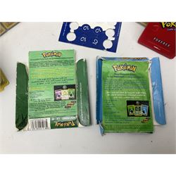 Collection of Pokemon trading cards, mostly 1999 Wizards Pokemon cards to include holo Charizard 4/102, first edition holo Machamp 8/102, further holographic cards; Dark Flareon 35/82 and Dark Vaporeon 45/82, cards from themed sets and 4th edition prints; 1998 Electronic Pokédex with cardboard boxes for themed decks Blackout, Overgrowth and Power Reserve Jungle, along with a large quantity of energy and trainer cards 