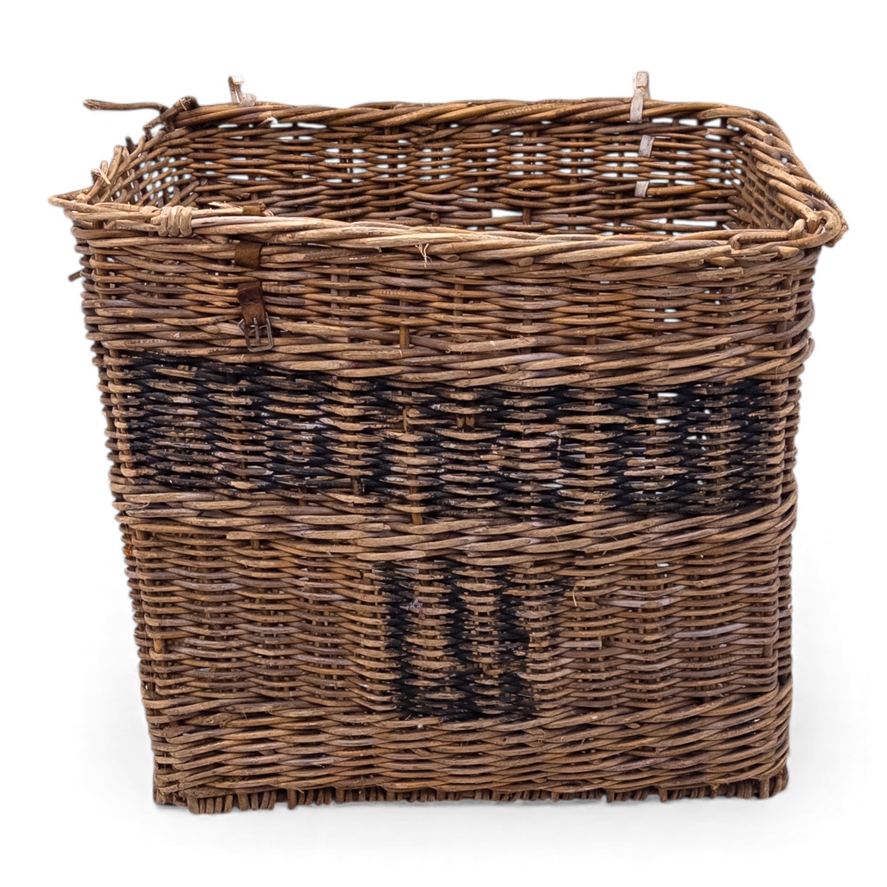Large 20th century wicker laundry basket, of rectangular form, with stencilled lettering to one sides, raised on wooden base skids