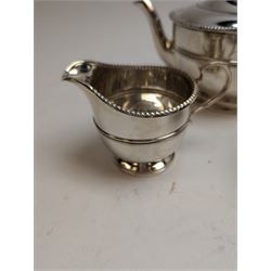 1930s silver three piece tea service, comprising teapot, milk jug and sugar bowl, each of circular form with oblique gadrooned rim, the teapot with Bakelite handle and finial, hallmarked Mappin & Webb Ltd, Birmingham 1931, teapot H14.5cm