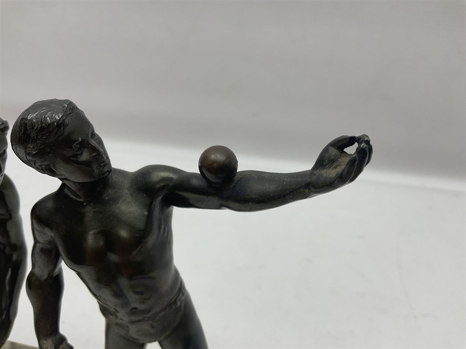 Bronzed model of the discus thrower and another of a episkyros player, both raised upon retangular plinths, H18cm