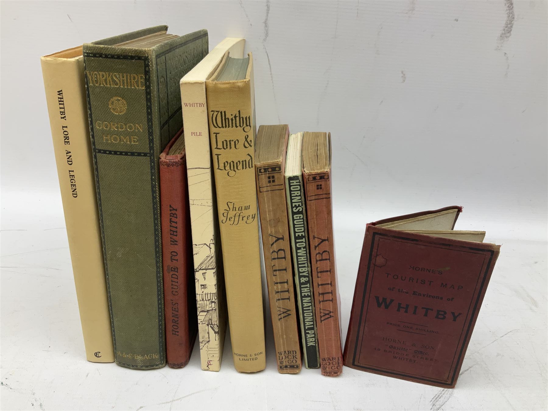 Quantity of books and postcards predominantly of Whitby interest including Hornes' Guide to Whitby 1890 and Hornes' Tourist map of Whitby, A Holiday Tour in and Around Whitby by H.S. Forman 1896 etc