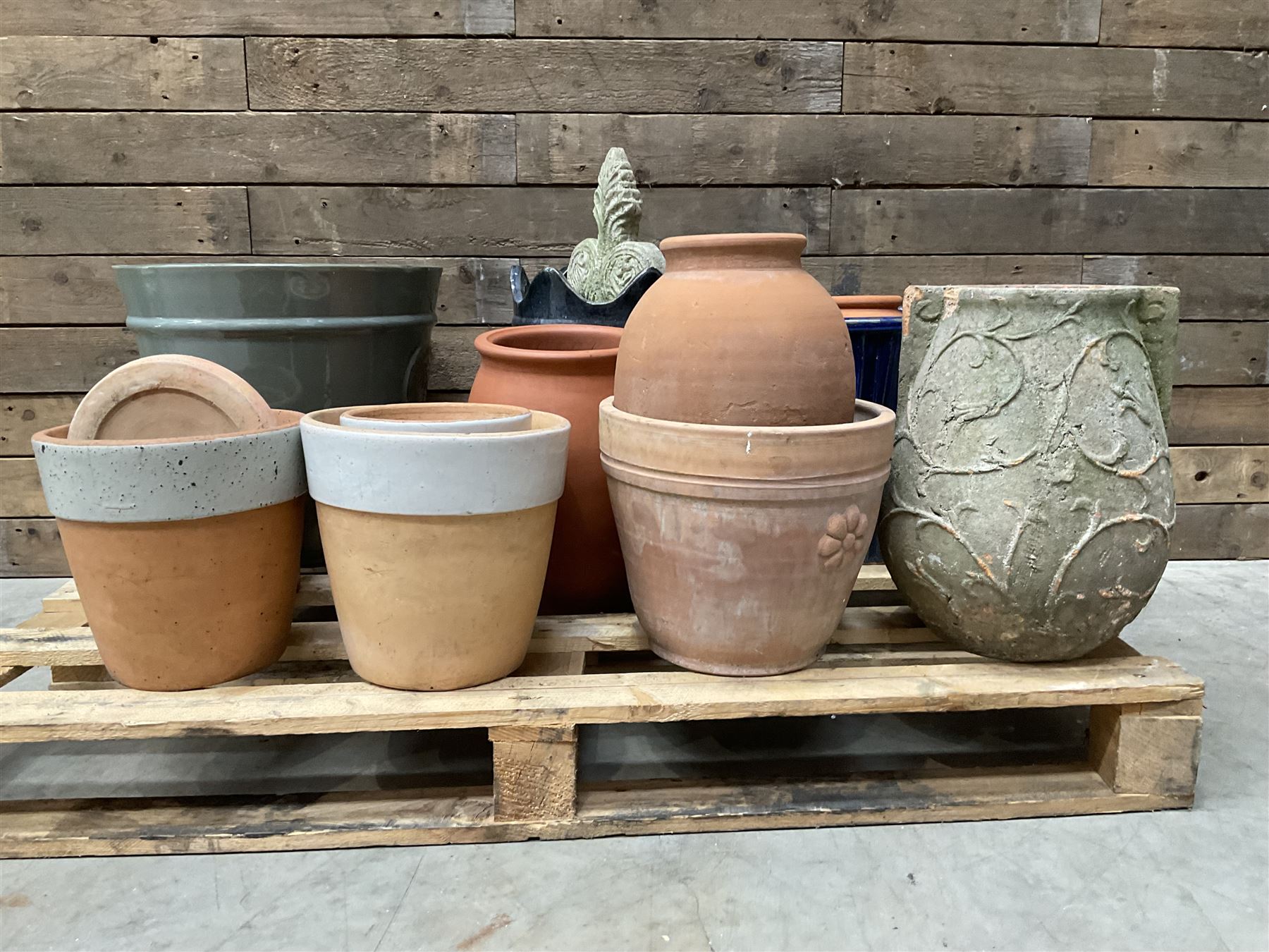 A quantity of various terracotta and glazed planters