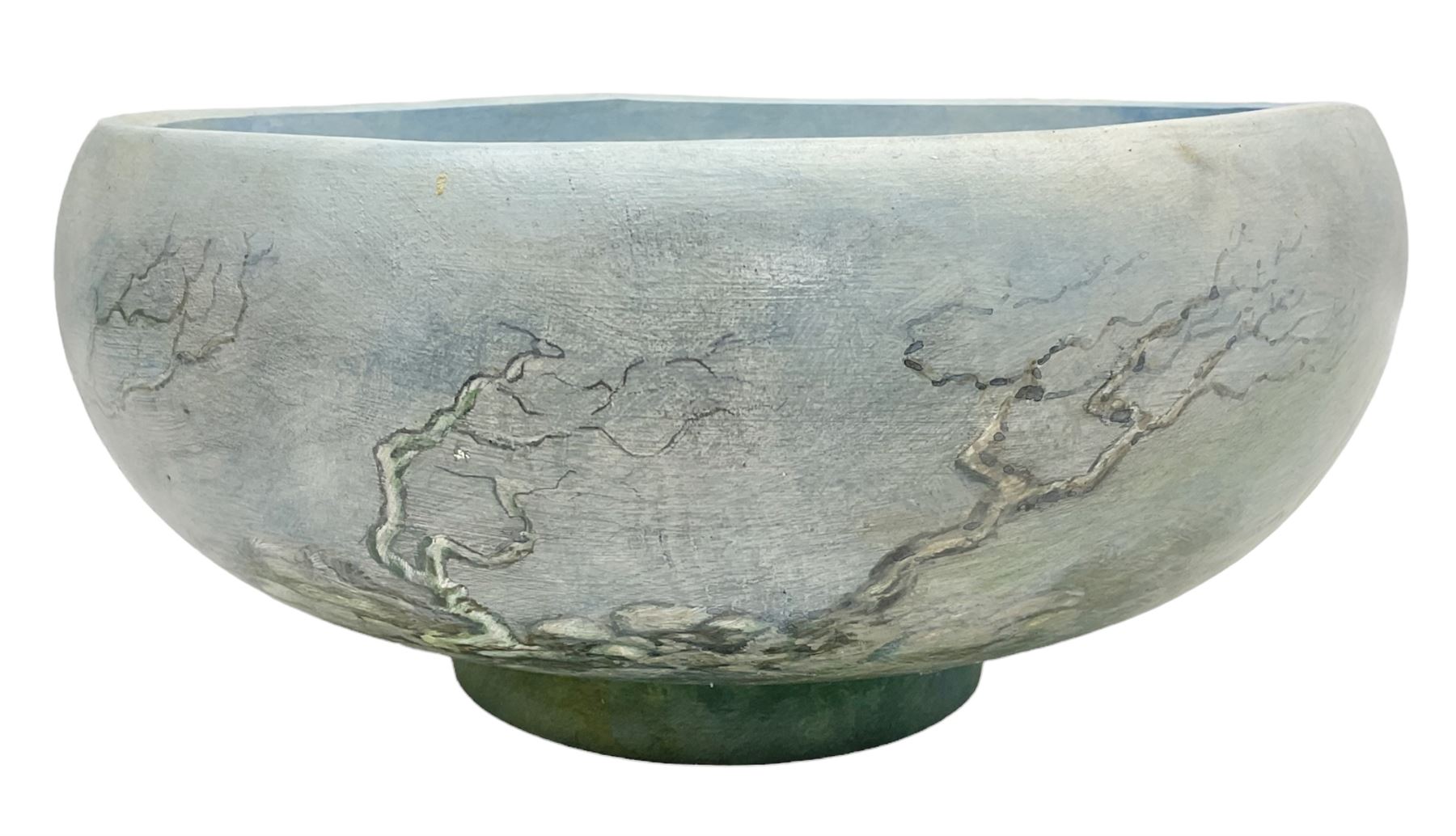 Wooden hand painted bowl, decorated with trees on a blue ground, signed Phil Crennell beneath, D28cm