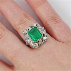 Platinum emerald and diamond cluster ring, single octagonal cut emerald of 2.52 carat, surrounded by milgrain set round brilliant cut and single cut diamonds, stamped PT950, total diamond weight 0.82 carat