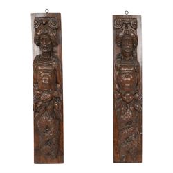 Pair of 17th century carved oak terms, each depicting a male figure in headpiece, with fish tail beneath fruits, 51.5cm