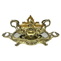 Ornate brass centrepiece, with twin handled vase upon a mirrored base, with floral and scrolling decoration, H23cm 