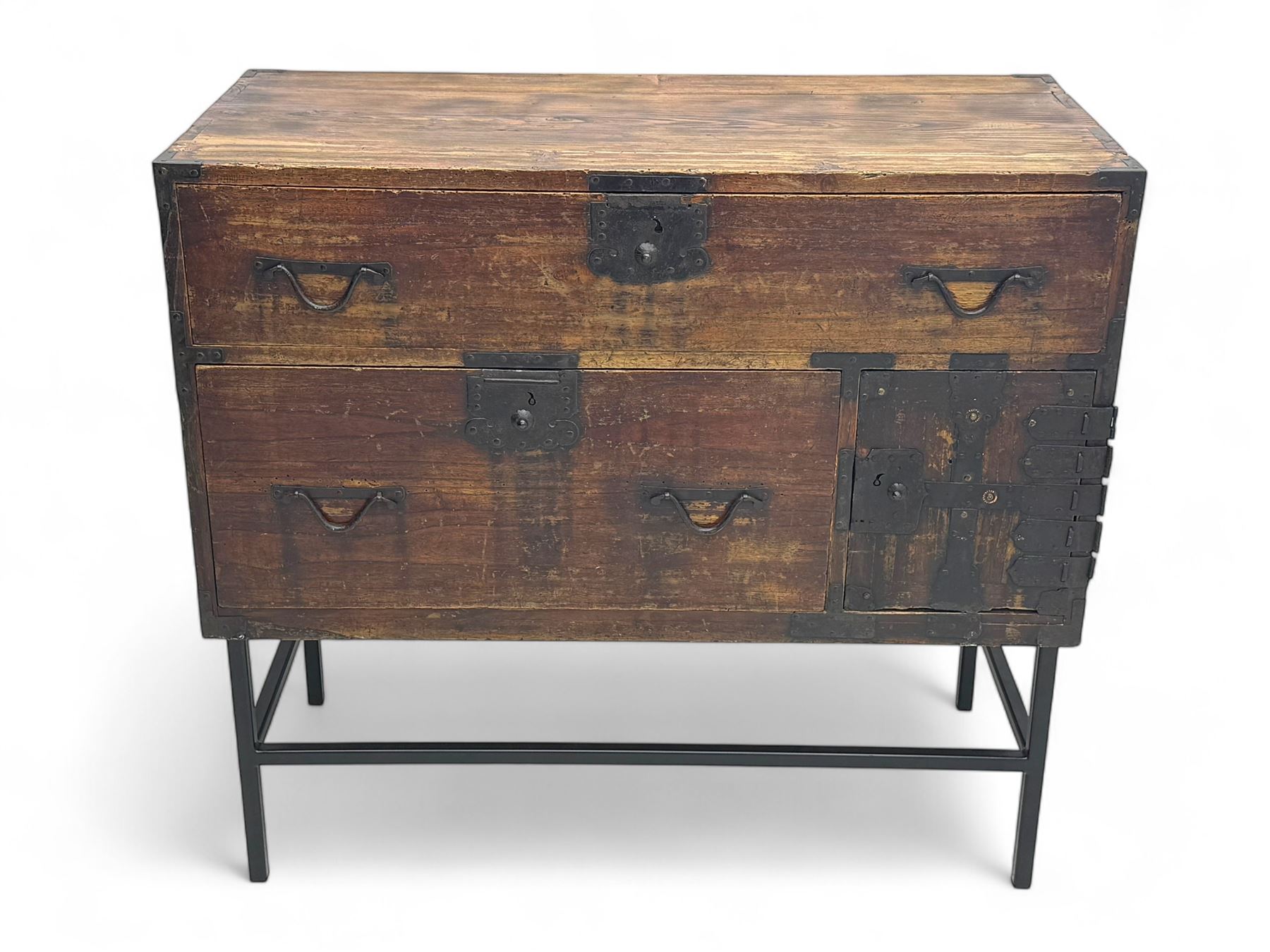 Late 19th century Japanese tansu chest, crafted with a cedar frame and cypress wood panels, original iron fittings throughout, comprising a single long drawer above smaller drawer and hinged cupboard door enclosing two smaller internal drawers and storage compartment, mounted on a bespoke black metal stand