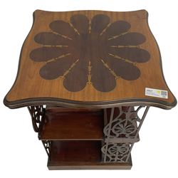 Edwardian mahogany revolving bookcase, the shaped moulded top inlaid with cusped panel and trailing bellflowers within a satinwood frame, foliate pierced upright splats and central square column supporting two tiers, on cruciform base with brass and ceramic castors 