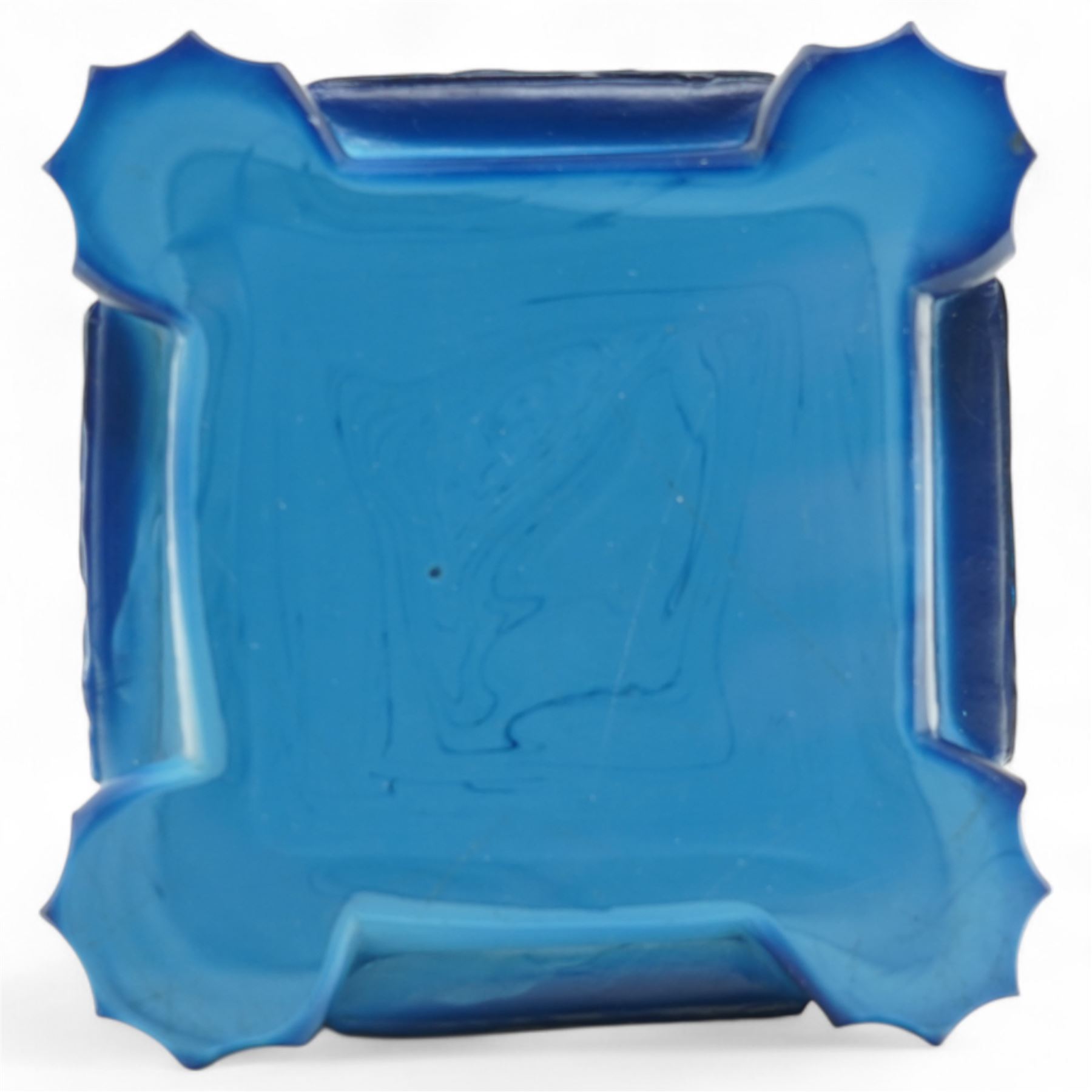 Early 20th century art deco style lapis glass ashtray, in the manner of Frantisek Pazourek, depicting a nude maiden astride a reared horse, possibly Lady Godiva, the bowl with raised foliate decoration, each side panel depicting leaping deer in light relief, flat base with fluted corner decoration, W7cm