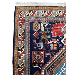 Persian Ardabil indigo ground rug, four interconnected lozenge medallions surrounded by ewer, bird, dragon, camel and geometric motifs, hooked border within guard stripes 