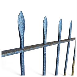 Two sections of painted iron garden or estate boundary railing, comprising a 19th century wrought iron section with graduated spearhead uprights, together with a later hoop-top section with ball-finial end posts, both in blue painted finish