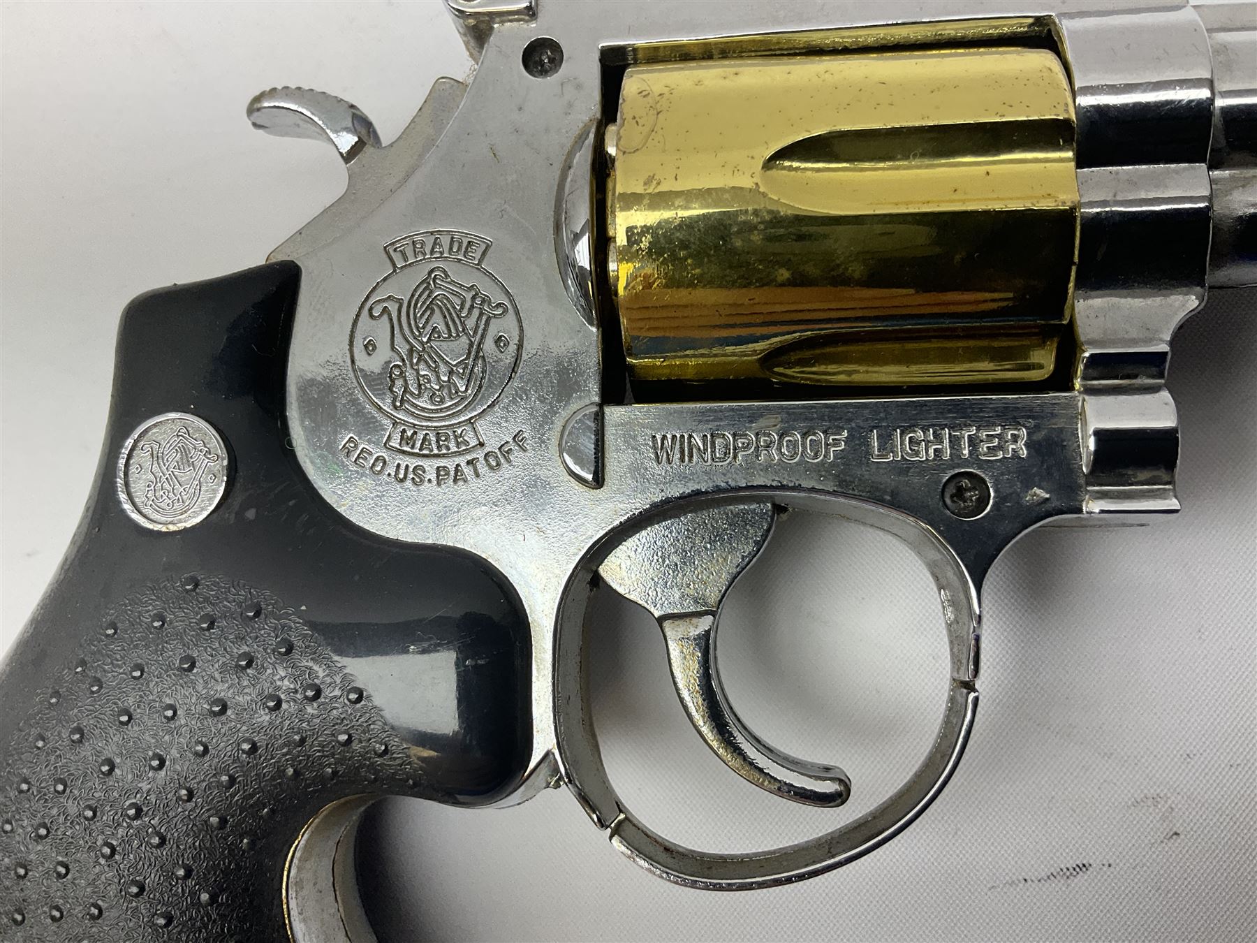 Early 20th century Flobert 5mm blank firing revolver with six-shot chamber, top venting, nickel plated with folding trigger No.118 L12.5cm overall; replica non-firing 'British Bulldog' revolver; and Windproof gas lighter inscribed 'Revolver-99 Spring and Autumn' in holster marked 'Star-Line'