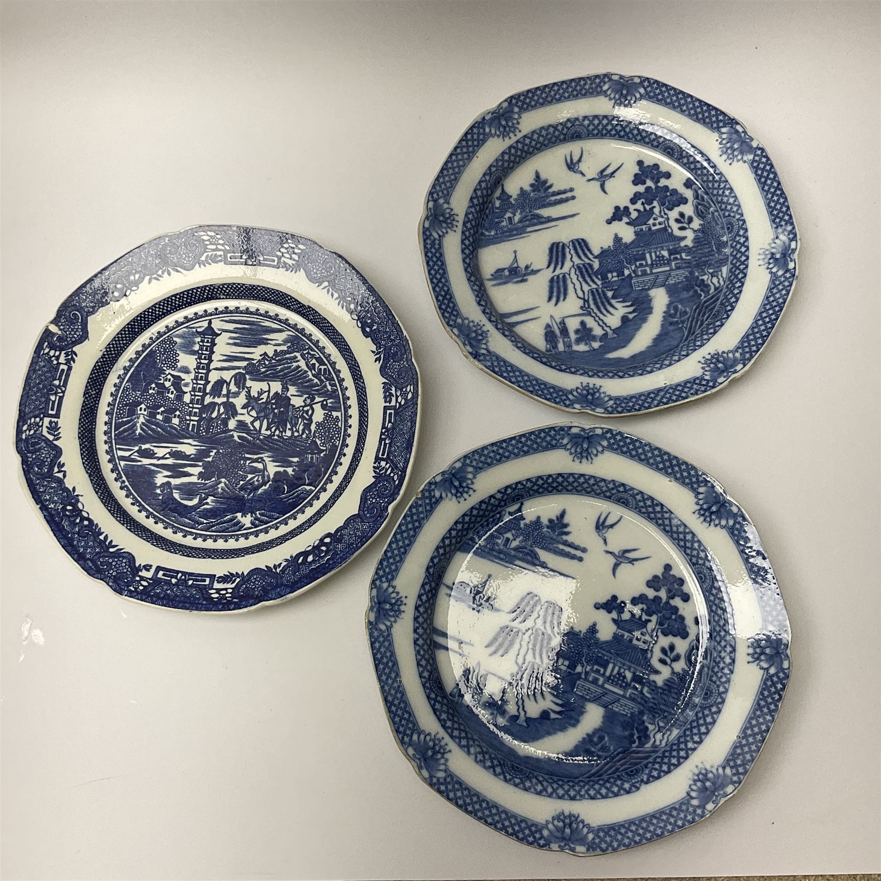 A group of 19th century blue and white transfer printed pottery, various makers and patterns, to include Minton Queen of Sheba pattern plate, Joshua Heath Reindeer pattern plate with towering pagoda, and seal in the foreground, a number of plates decorated in the Chinoiserie Bridgeless pattern, two Mandarin type pattern plates, possibly Spode, etc. 