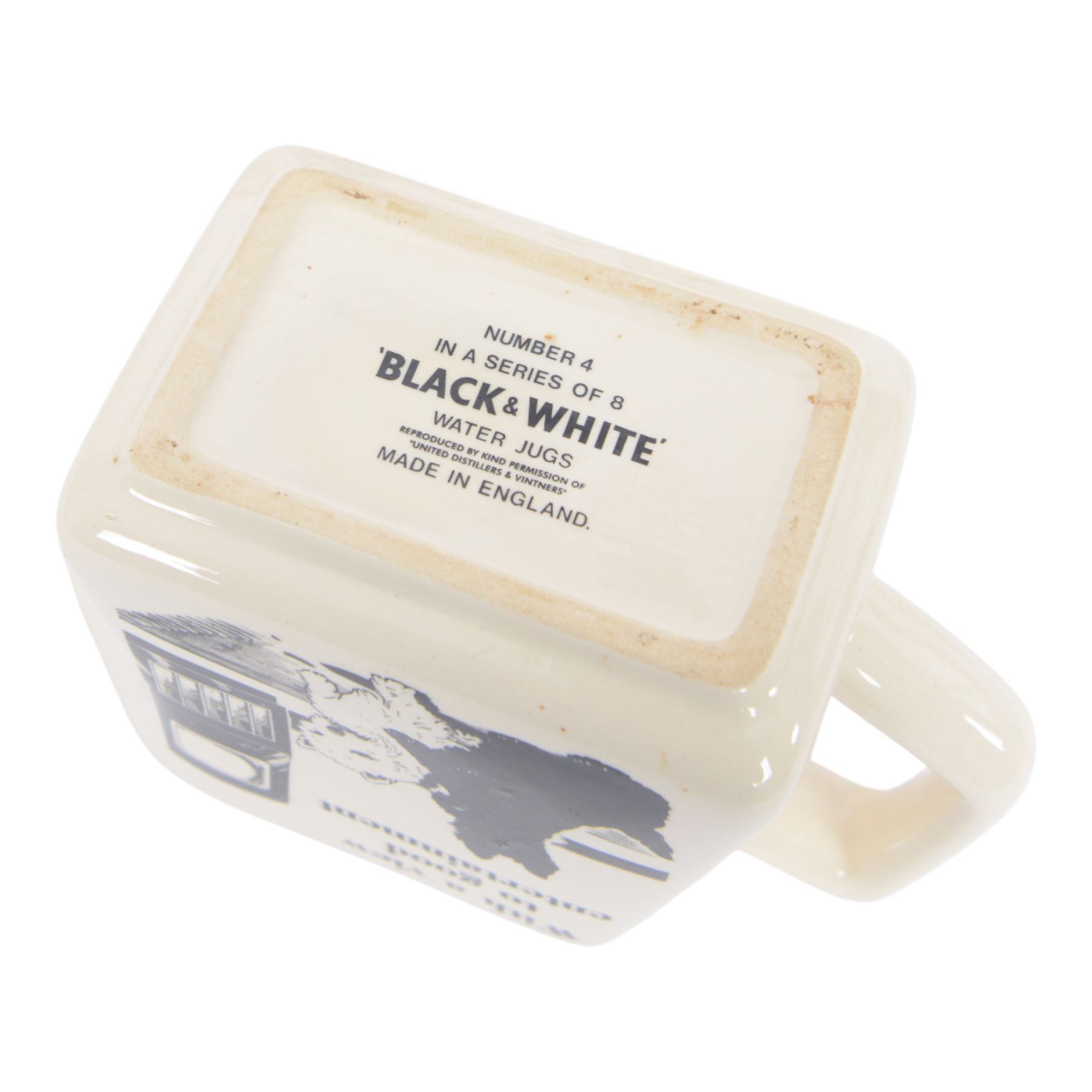 Eight Black and White Scotch Whisky advertising jugs