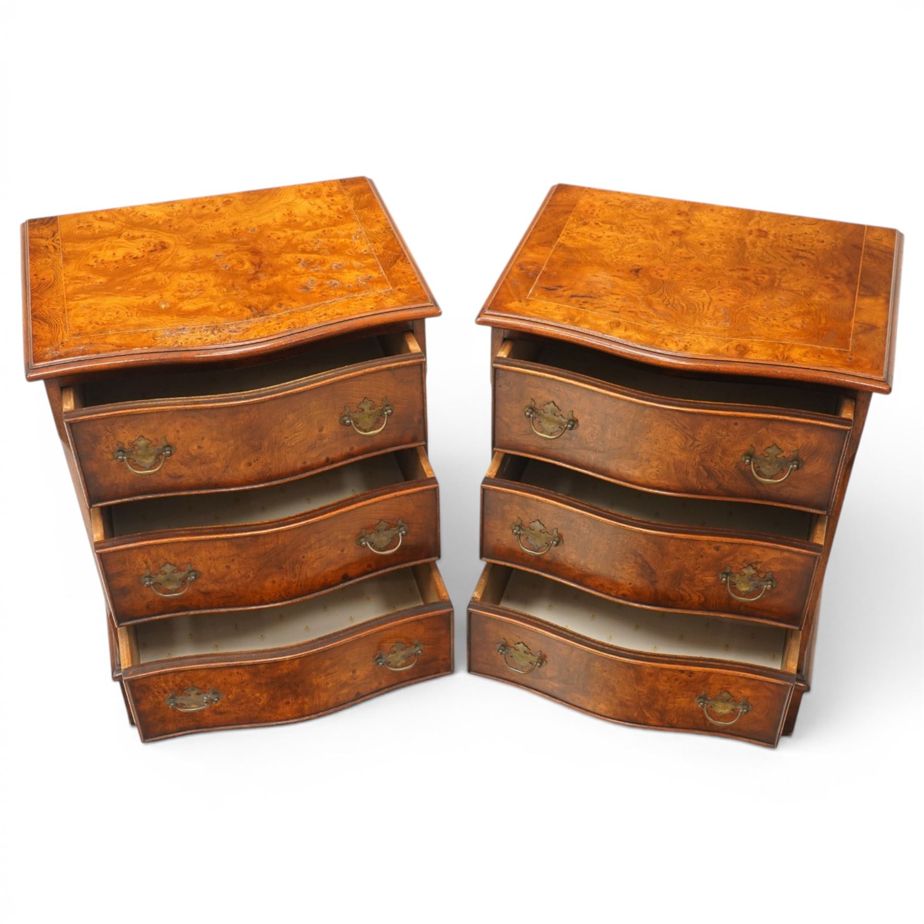 Pair of Georgian design figured elm serpentine bedside chests, moulded top raised on bracket feet