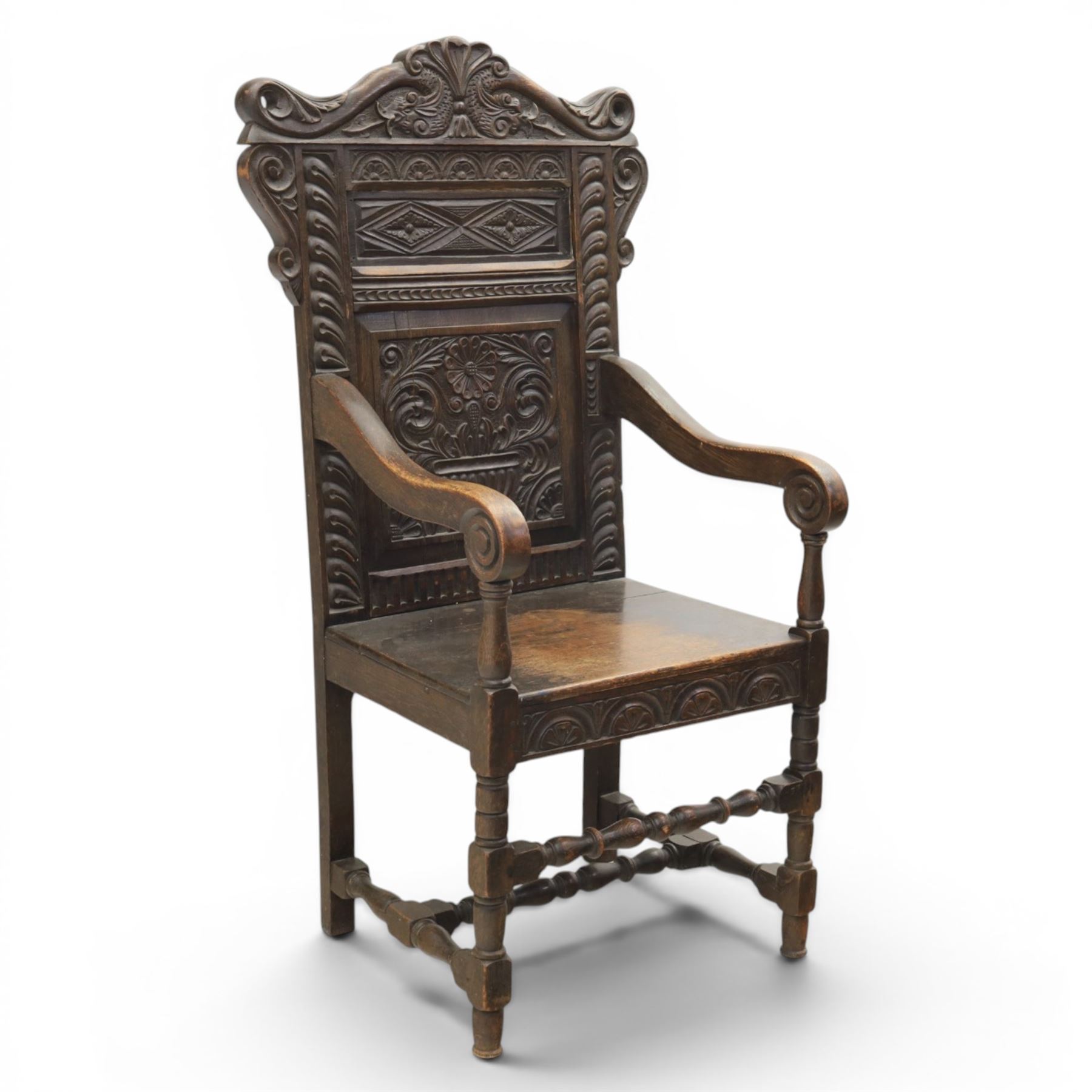17th century style carved oak Wainscott chair, intricately carved back, united by a turned stretcher