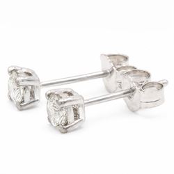 Pair of platinum diamond earrings, each stud four claw set with a single round brilliant cut diamond, stamped Pt 950, total diamond weight approx 0.55 carat