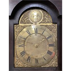 Late 18th century oak longcase clock, projecting cornice over glazed stepped arch hood door, plain rectangular case, the brass dial with circular plate inscribed 'G.H', Roman and Arabic chapter ring, the inner dial decorated with a series of circular motifs, ornate bird and scroll cast spandrels, 30-hour movement striking the hours on bell