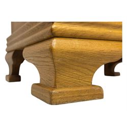 Frank Hudson - contemporary pair of light oak bedside cabinets, each with moulded rectangular top over single drawer above cupboard door with arched panel, on a moulded plinth base with bracket feet