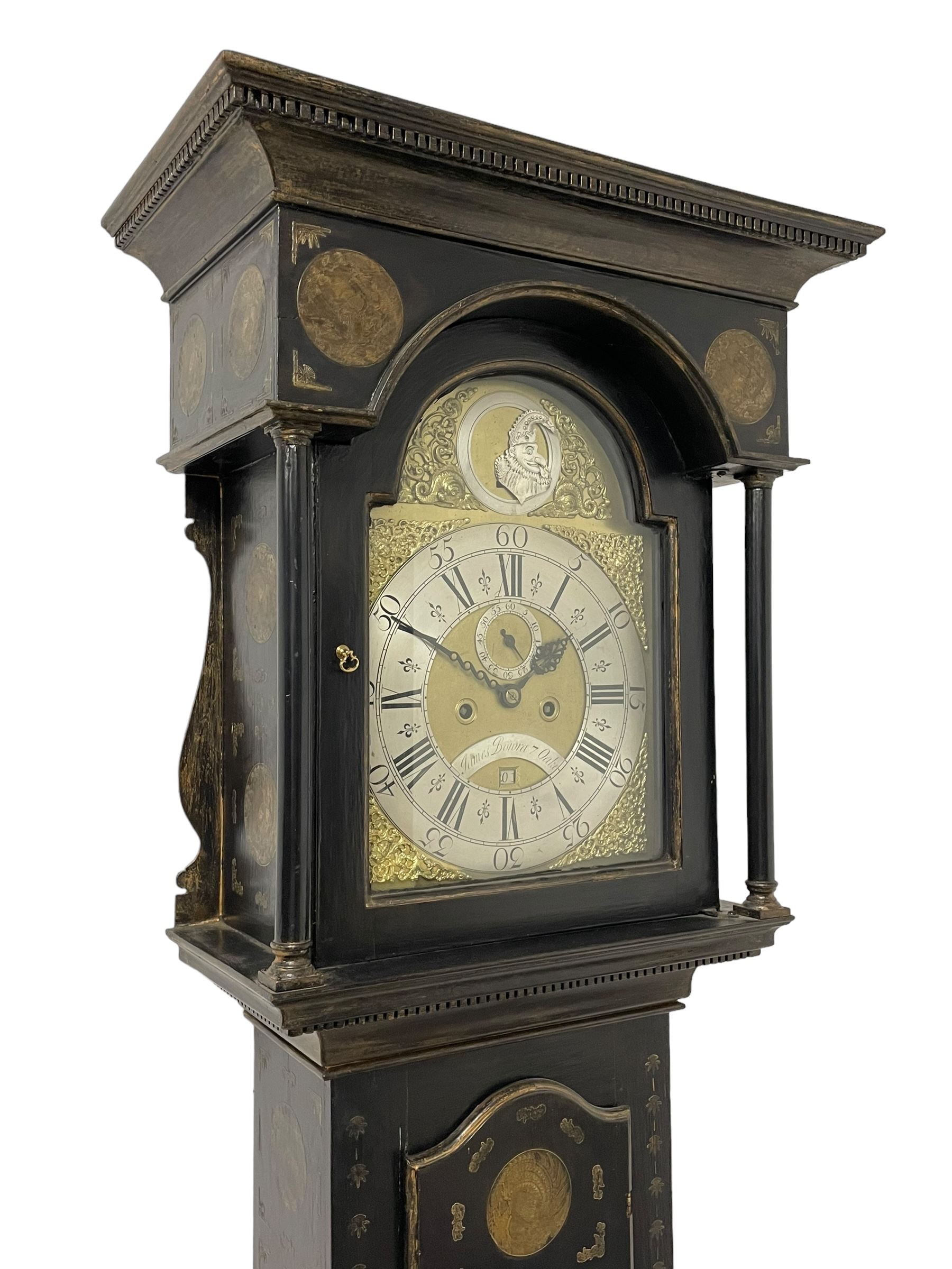 James Bowra of Sevenoaks Kent - 18th century 8-day ebonised longcase clock with gilt decoration c1740, with a flat top, dentil moulding beneath and shaped back splats, break arch hood door flanked by plain pilasters with wooden capitals, long trunk with a curved topped door, on a square plinth with canted corners and raised on a moulded base, brass dial with cast spandrels and a silvered 'Punch' automata to the arch, matted dial centre with seconds ring and date aperture, silvered chapter ring with Roman numerals, five minute Arabics, minute and quarter hour tracks, with matching steel hands and silvered makers name plate, rack striking movement with a recoil anchor escapement, striking the hours on a bell. With weights and pendulum.