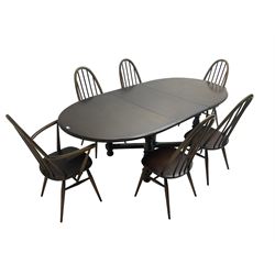Ercol - 'Old Colonial' 705 elm extending dining table, oval top with hidden leaf, raised on turned supports united by X-stretcher (W163cm D108cm H72cm); and Ercol - set six  (4+2) dark elm 'Quaker Back Windsor Dining Chairs', hoop and stick backs 