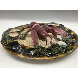 Two 20th Century Portuguese Palissy style Majolica wall plates, one depicting a crab, the other a lobster each to the centre modelled in relief surrounded by encrustations and shells, both with impress marks beneath, D32cm