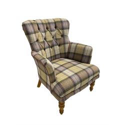 Traditional shaped armchair, upholstered in deep buttoned purple tartan fabric with red piping, raised on turned and tapering stained beech supports