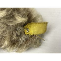 Steiff teddy bear with golden plush body, revolving head, applied eyes, vertically stitched nose and mouth and jointed limbs; button to left ear H26cm; and two other Steiff teddy bears, each with open mouth and button with tag to left ear (3)
