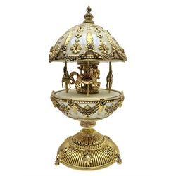  Franklin Mint House of Faberge; The Faberge Imperial Carousel Egg, with a carousel that revolves to the sound of the musical box operated by the winding key finial, H27cm