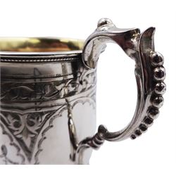 Victorian silver mug, with engraved strapwork decoration, curved and stylised handle, and beaded edge to rim and spreading circular foot, with later gilding to interior, hallmarked George Unite, Birmingham 1872, H9.5cm, approximate weight 3.72 ozt (115.8 grams)