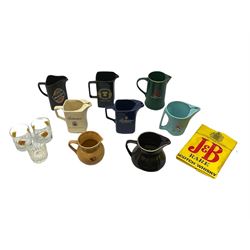 Eight whisky water jugs, comprising Carling Black Label, Tennent's Extra, Ballantine's (2), Glenmorangie, Teacher's, Wade Johnnie Walker (chipped), and J&B, together with three J&B whisky glasses and a J&B carrier bag (12)