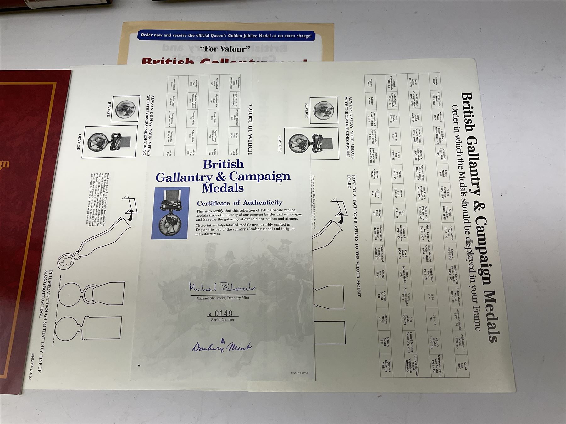 Two limited edition large framed display boards with half-size copies of British Gallantry and Campaign Medals produced by Danbury Mint and entitled 'For Valour'. Sixty medals on each board, all with ribbons. Complete with Danbury Mint certificate serial number A0148 and other paperwork.