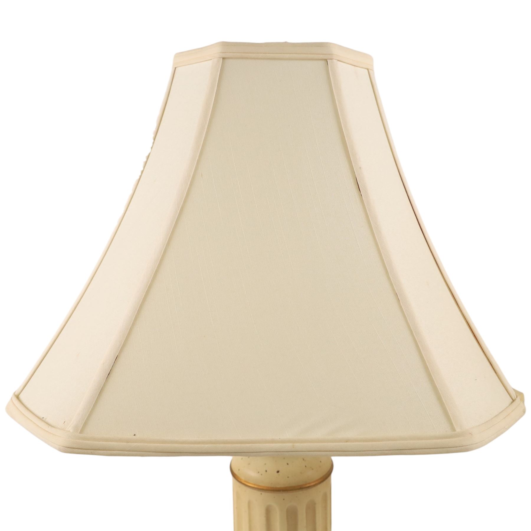 Pair of table lamps, the central column with gilt and and black bands and a foliate boarder, with cream shades, H58cm without shades 